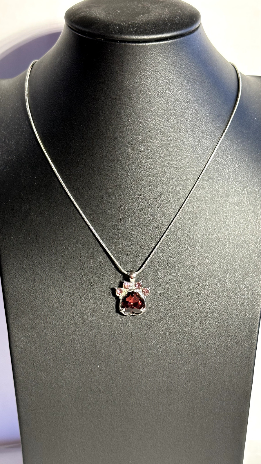 Paw shaped necklace with jeweled inlay on silver chain with 4″ ext rs5/55
