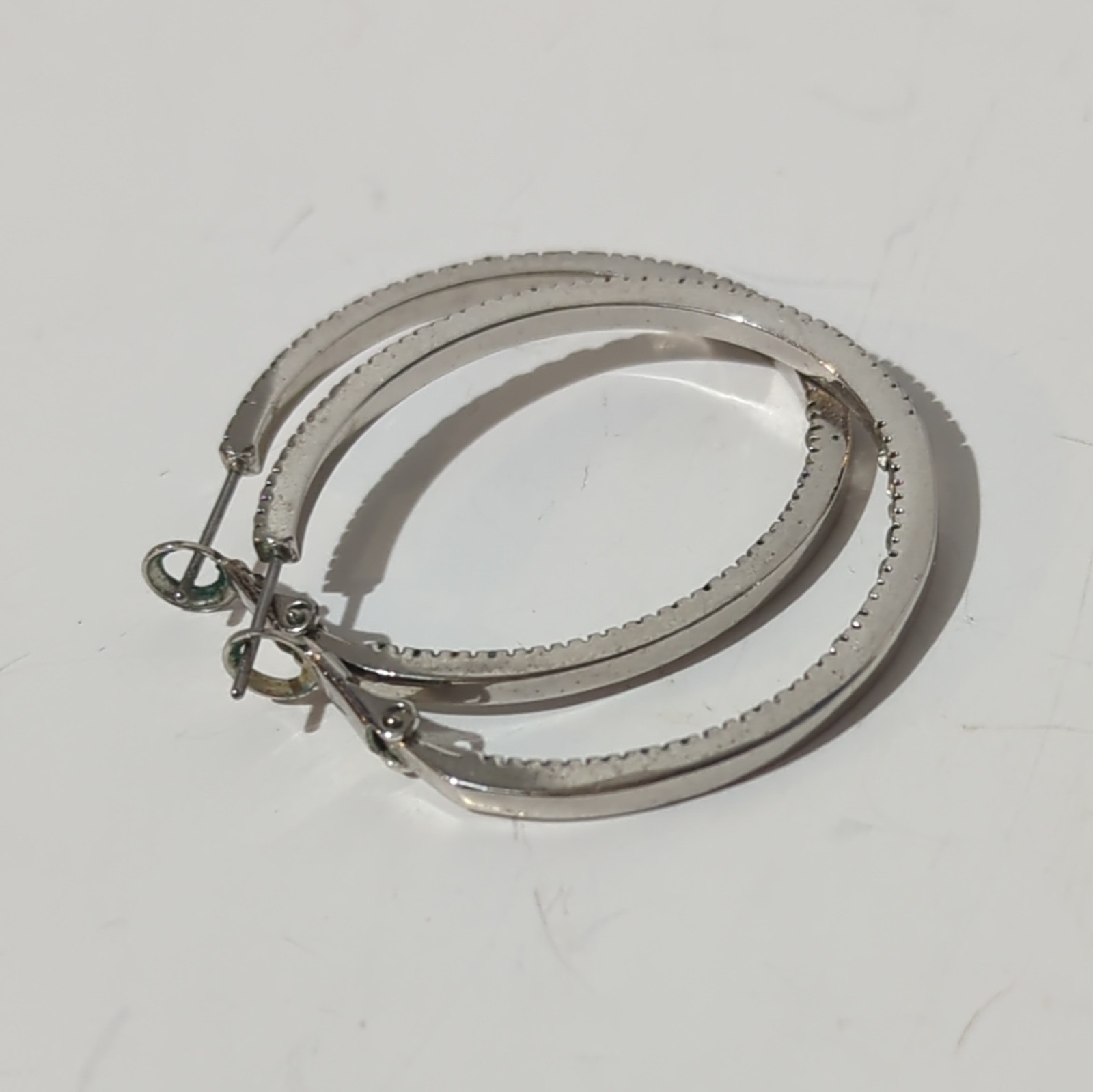Touchstone Crystal by Swarovski Silver Tone Inside-Out Clear Pavé Hoop Earrings
