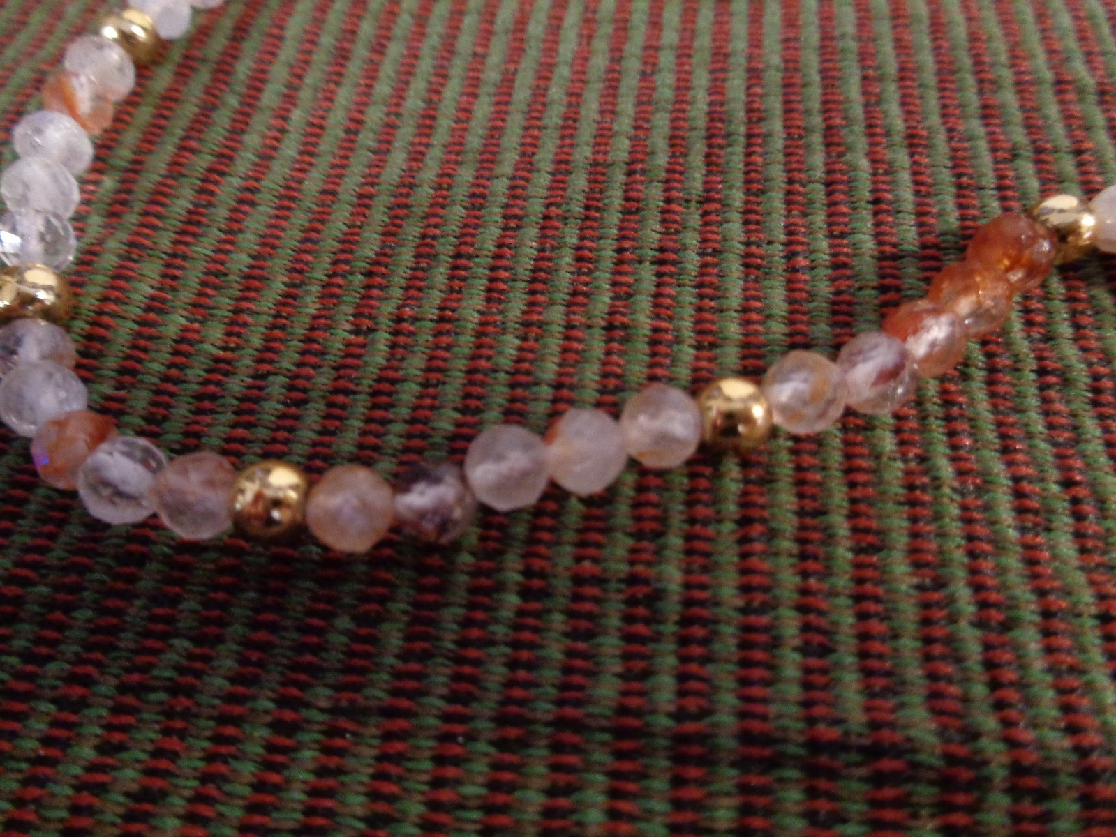 Artisan crafted,18”red rutilated quartz strand, hand knotted on silk, featuring