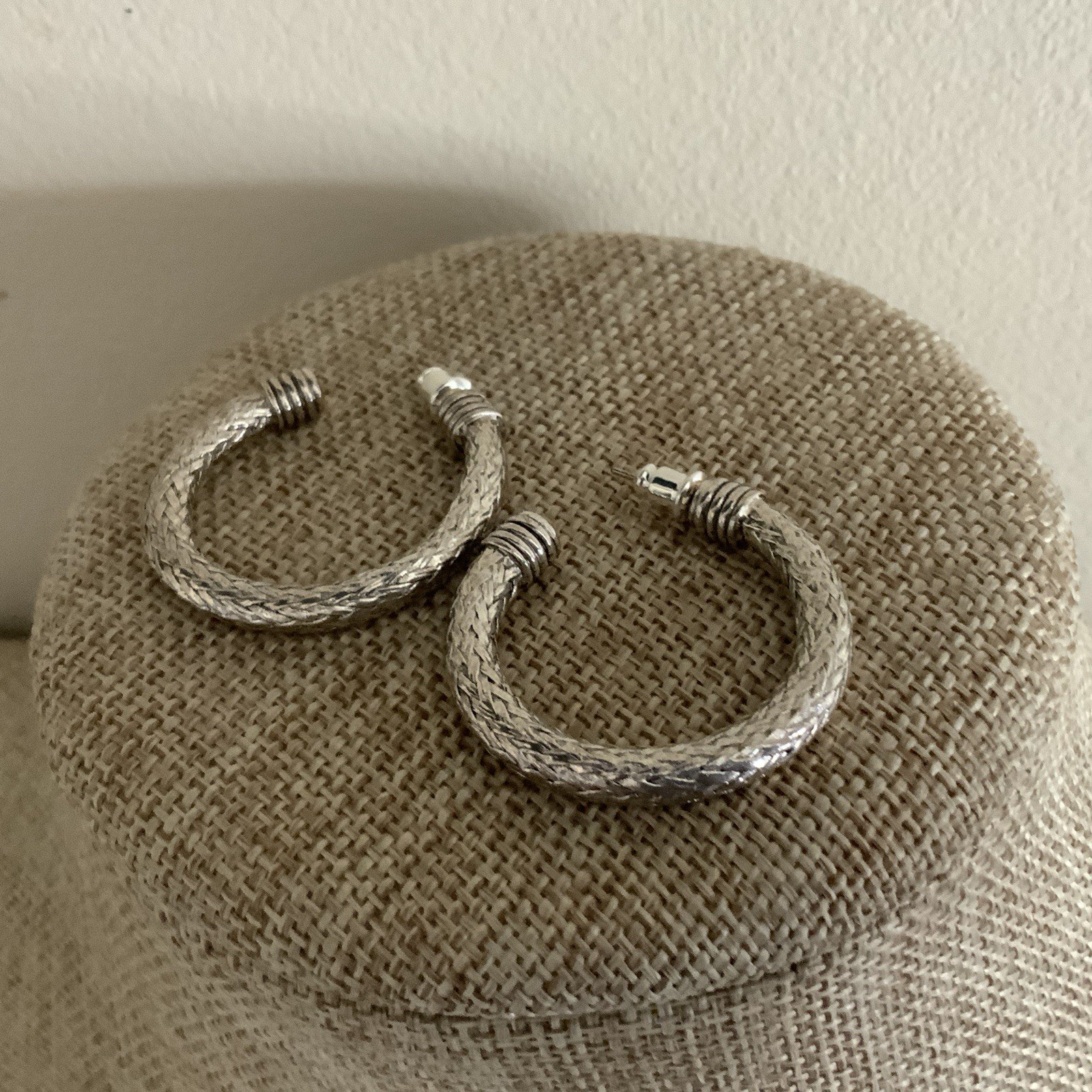 Pierced silver tone braided mesh wire hoop earrings