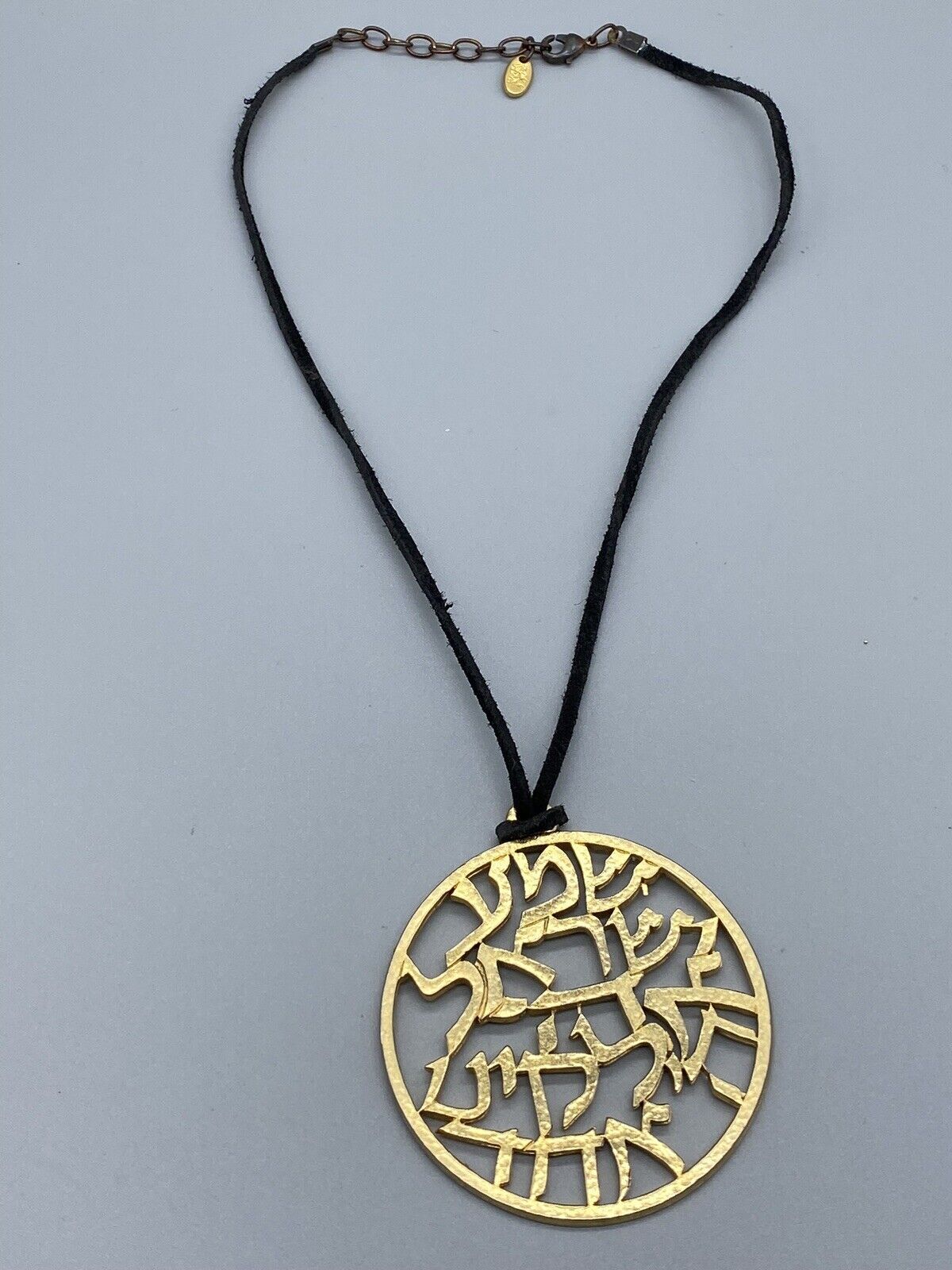 SAGA HIEROGLYPH GOLD TONE ROUND PENDANT BLACK LESTHER NECKLACE