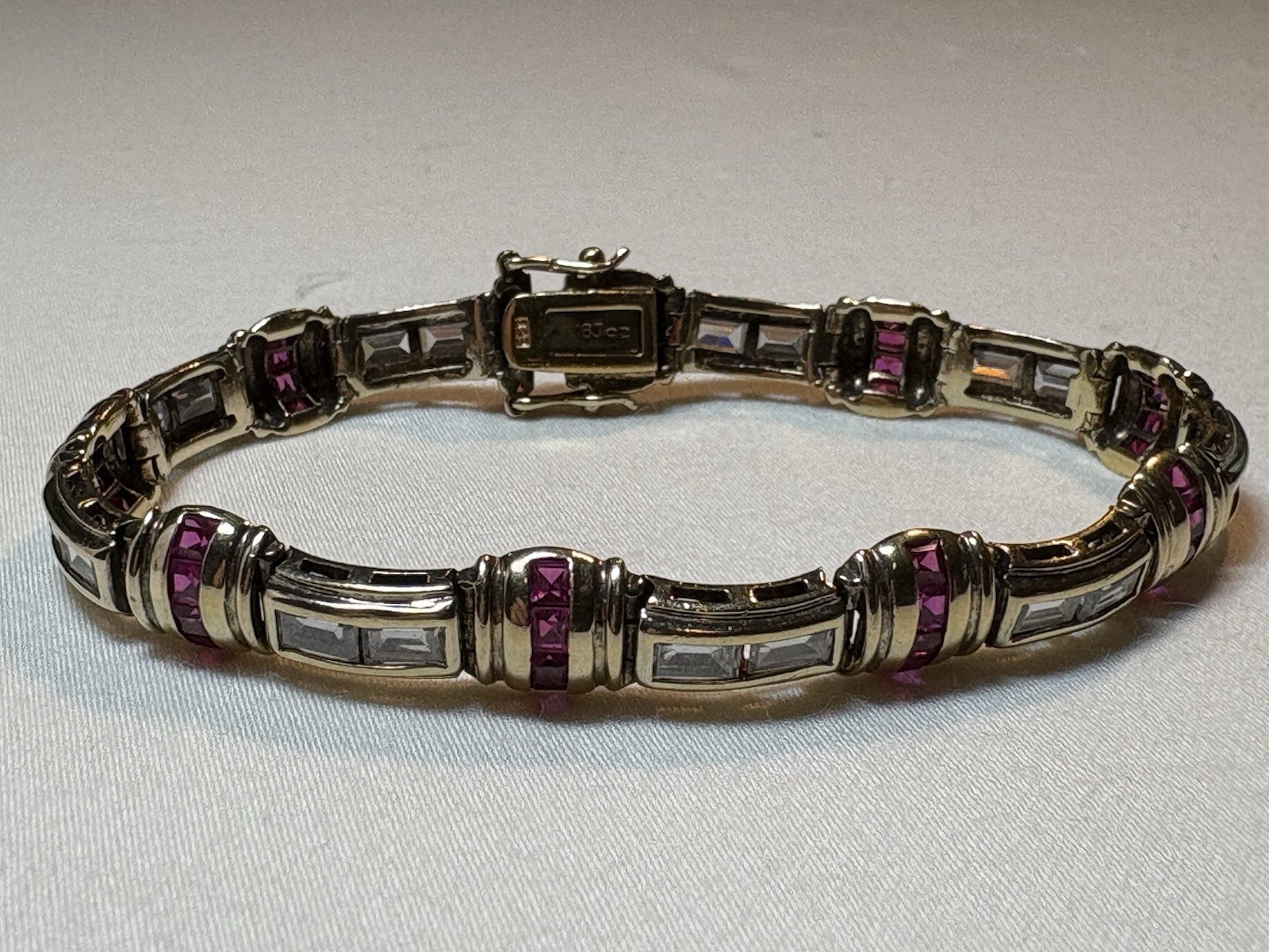 A sterling silver bracelet featuring baguette and round cubic zirconia stones.