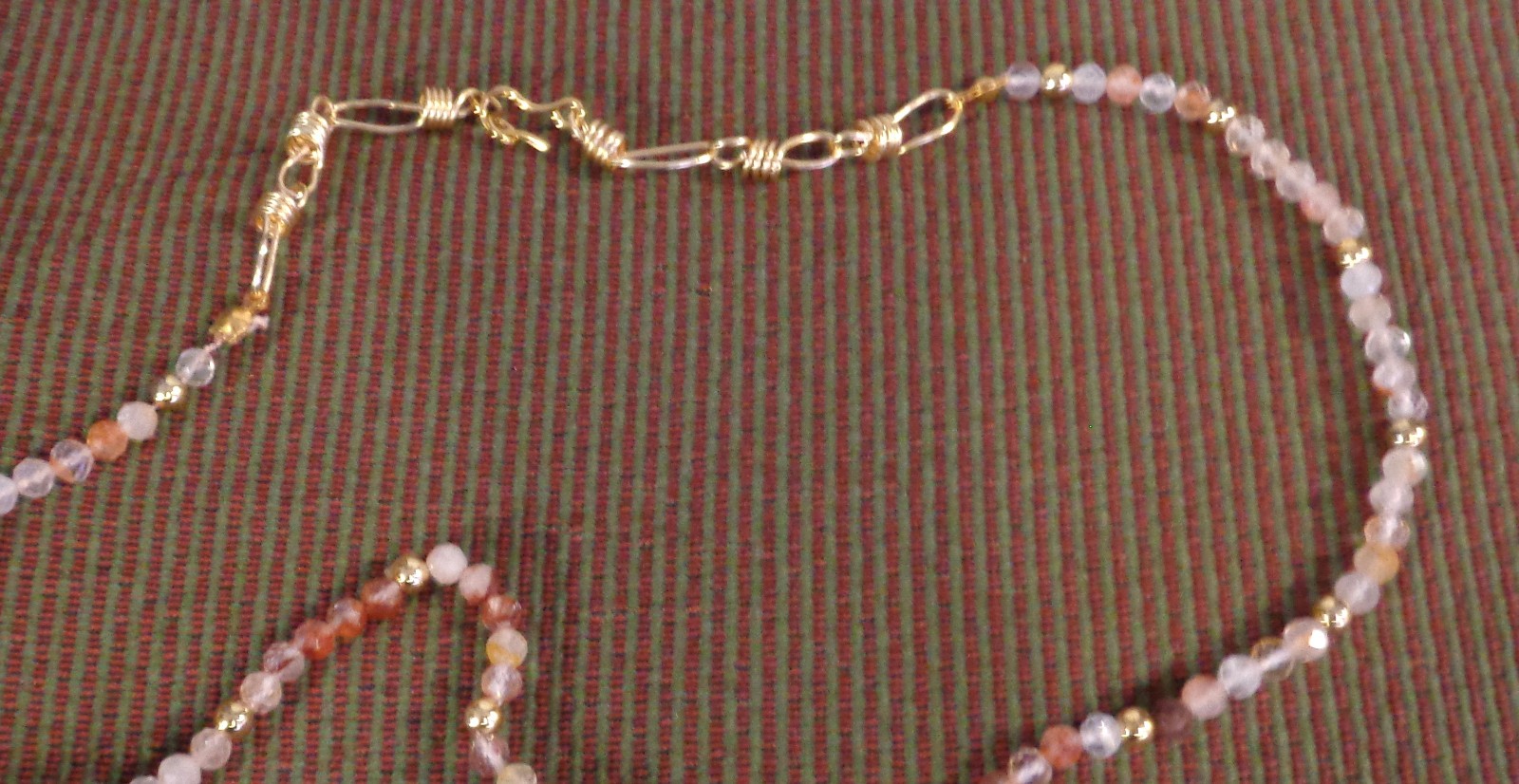 Artisan crafted,18”red rutilated quartz strand, hand knotted on silk, featuring