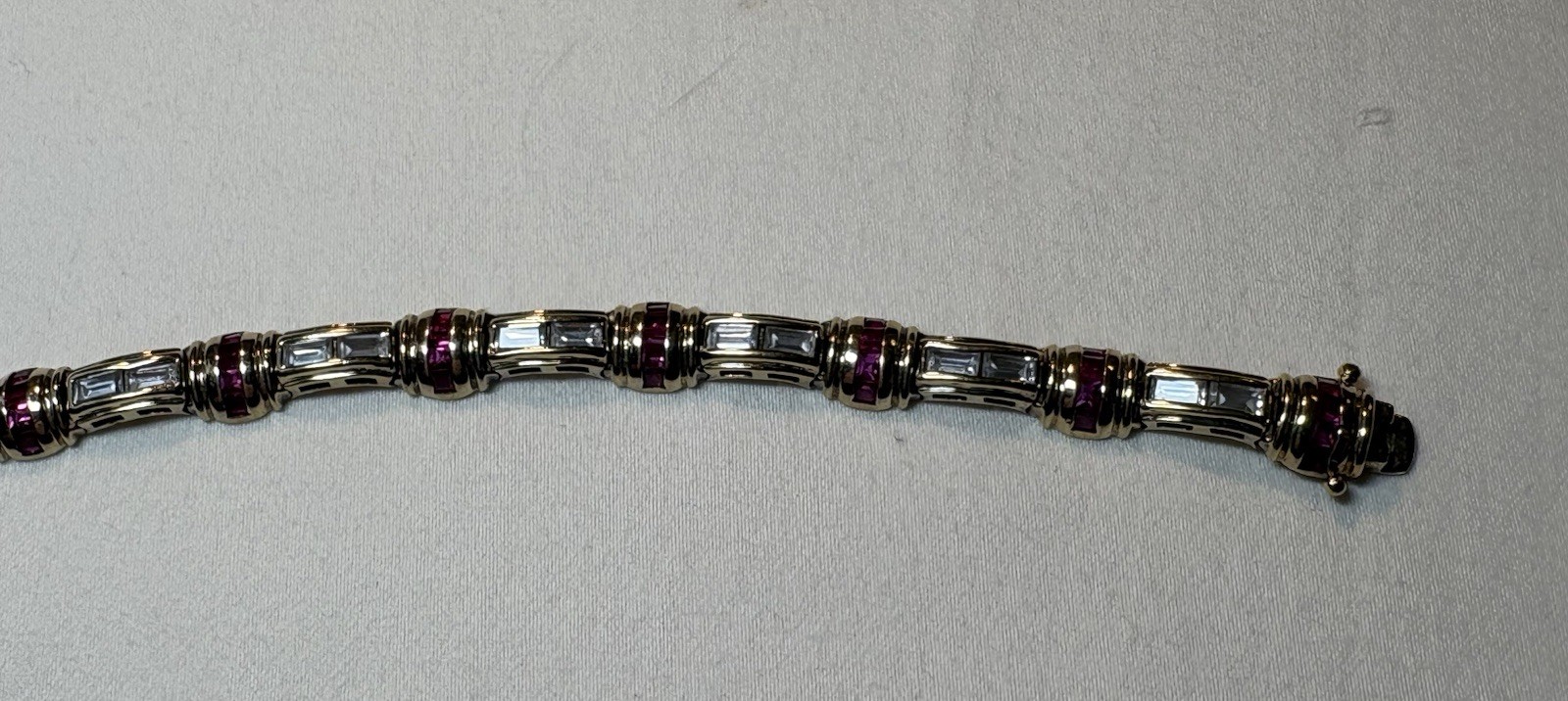 A sterling silver bracelet featuring baguette and round cubic zirconia stones.