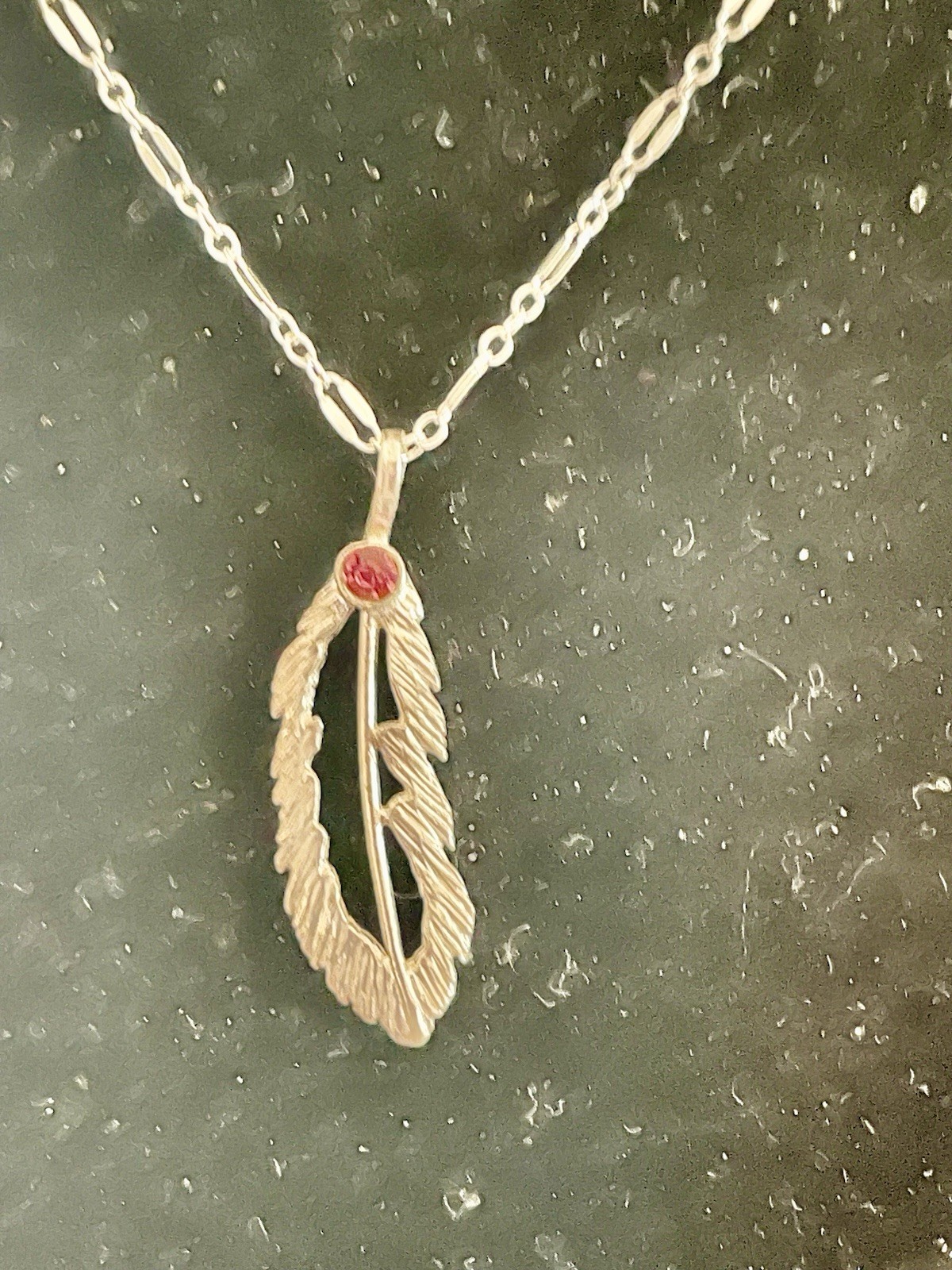 Open Sterling silver 1” Feather On 18” Figaro chain w/ Red Crystal.