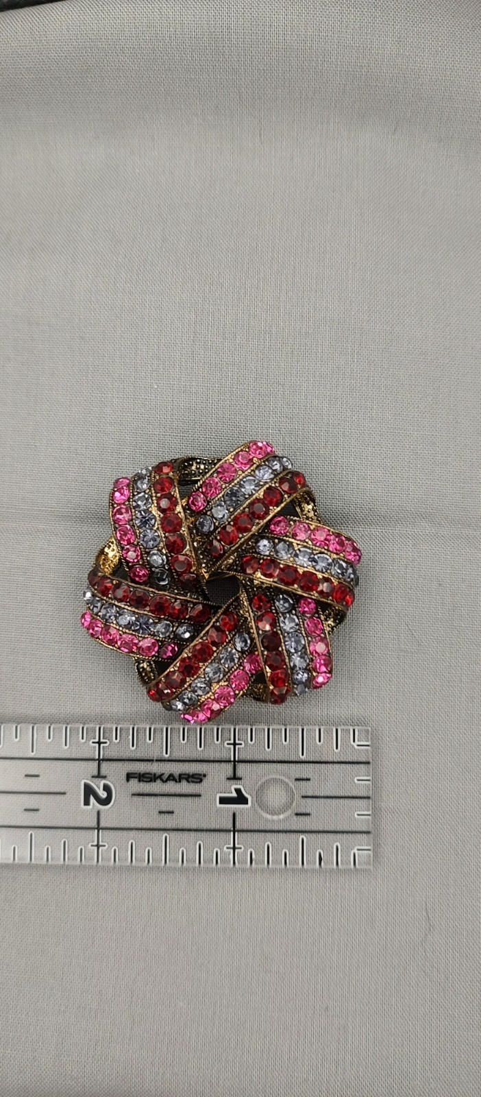 Monet rhinestone knot/ ribbon brooch of the 1970s to mid-1980s in ruby deep red