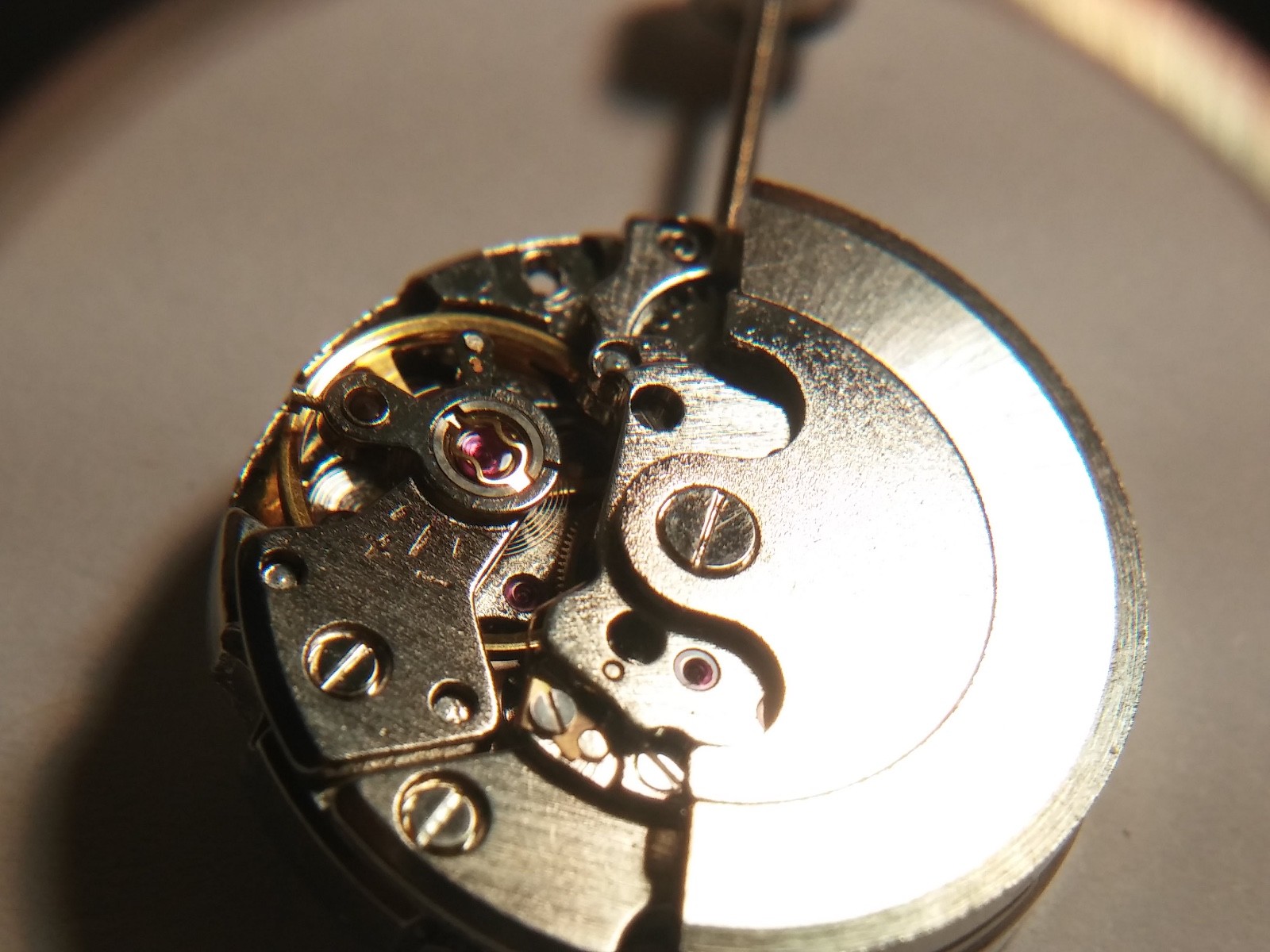 Automatic watch movement, winds. winding stem, running, 19.7mm diameter. no mark