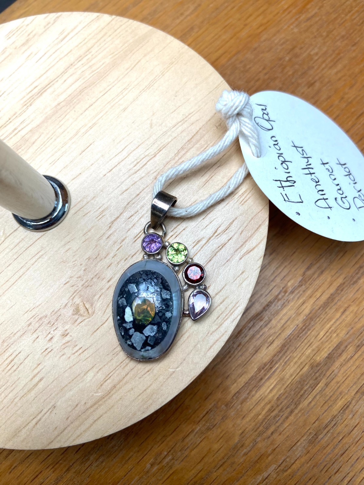 Ethiopian Opal Pendant with Amethyst, Ruby and Peridot accent stones.