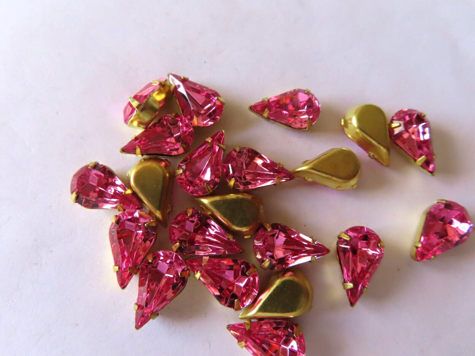 24 Swarovski Pearshape Rhinestones 13×7.8mm Rose/ Brass settings.