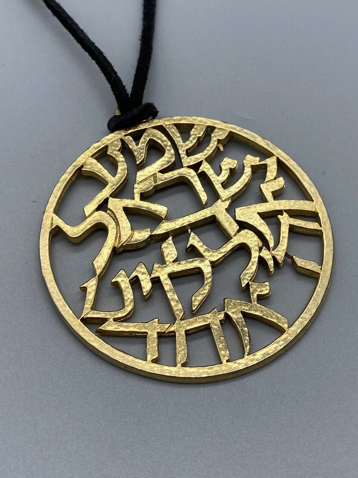 SAGA HIEROGLYPH GOLD TONE ROUND PENDANT BLACK LESTHER NECKLACE