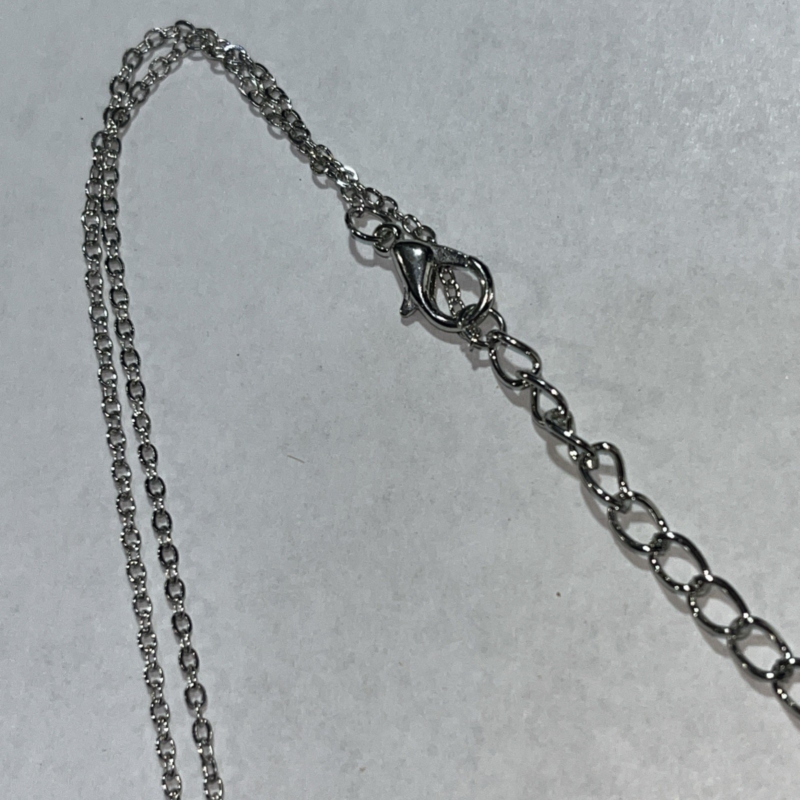Blue rhinestone necklace in silvertone cage 14″ adjustable
