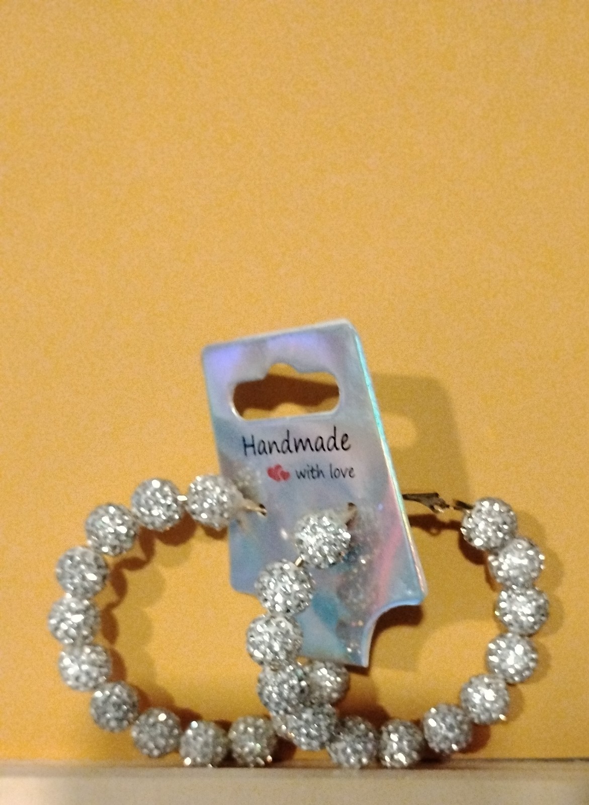 Big silver hoops with balls covered in diamonds earings
