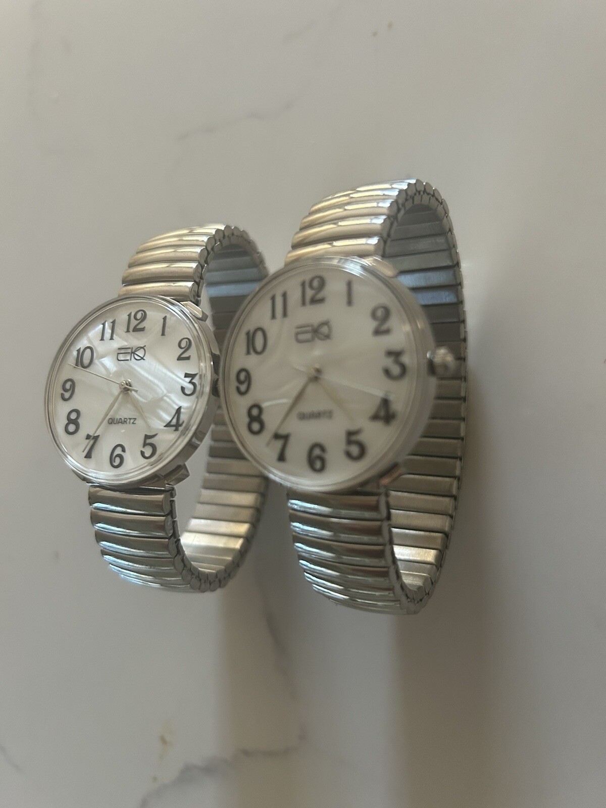 Buyer gets 2 new silver stretch band watches with large easy to read numbers