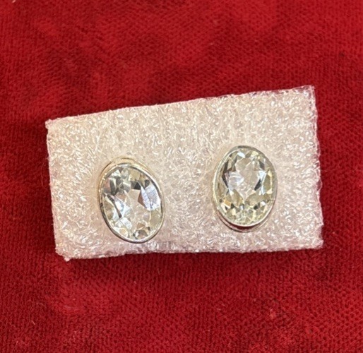 7 Mm X 9 Mm Oval Shaped White Topaz stud earrings Set In Sterling Silver