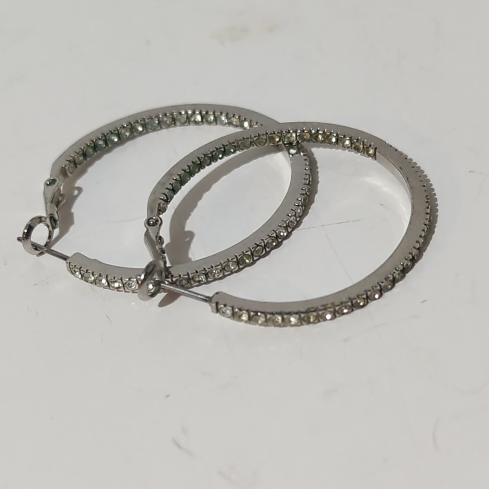 Touchstone Crystal by Swarovski Silver Tone Inside-Out Clear Pavé Hoop Earrings