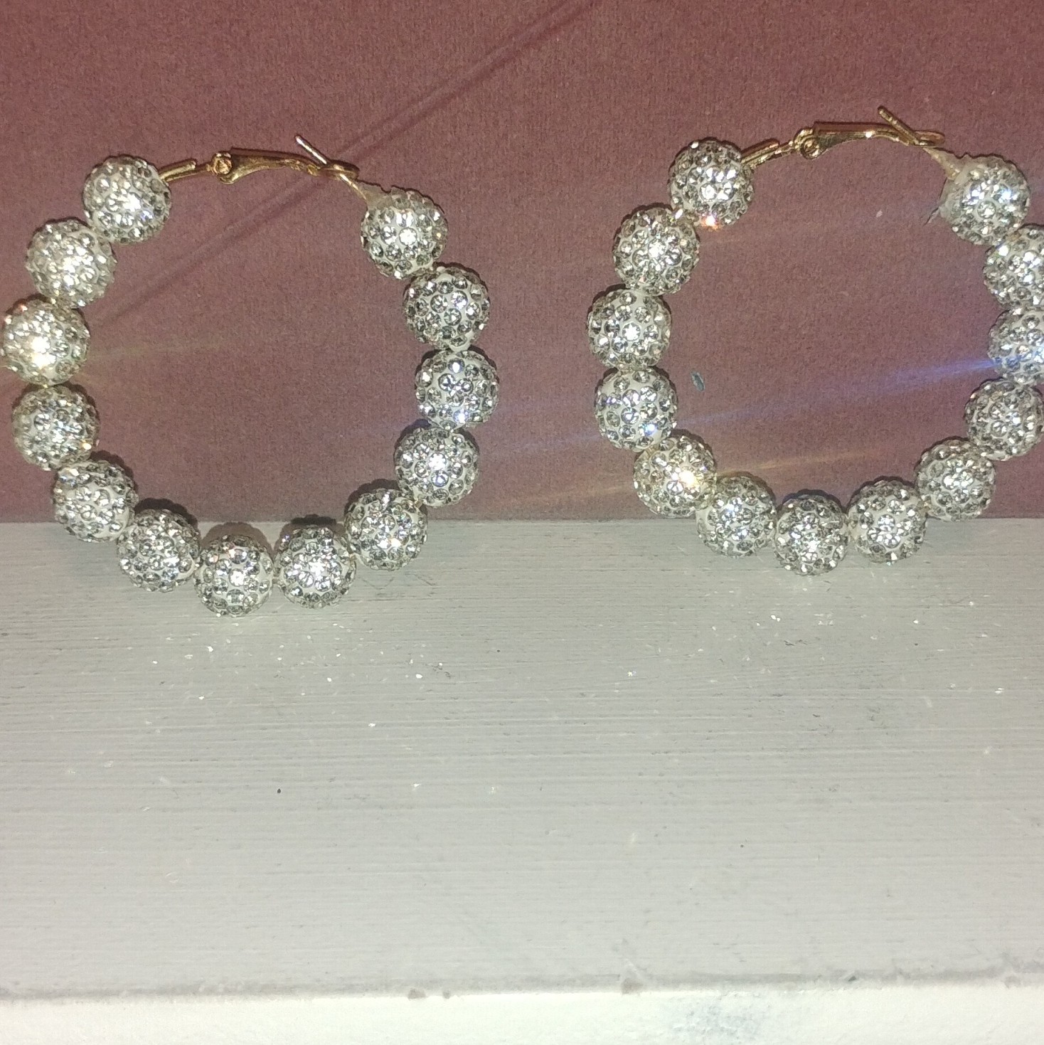 Big silver hoops with balls covered in diamonds earings
