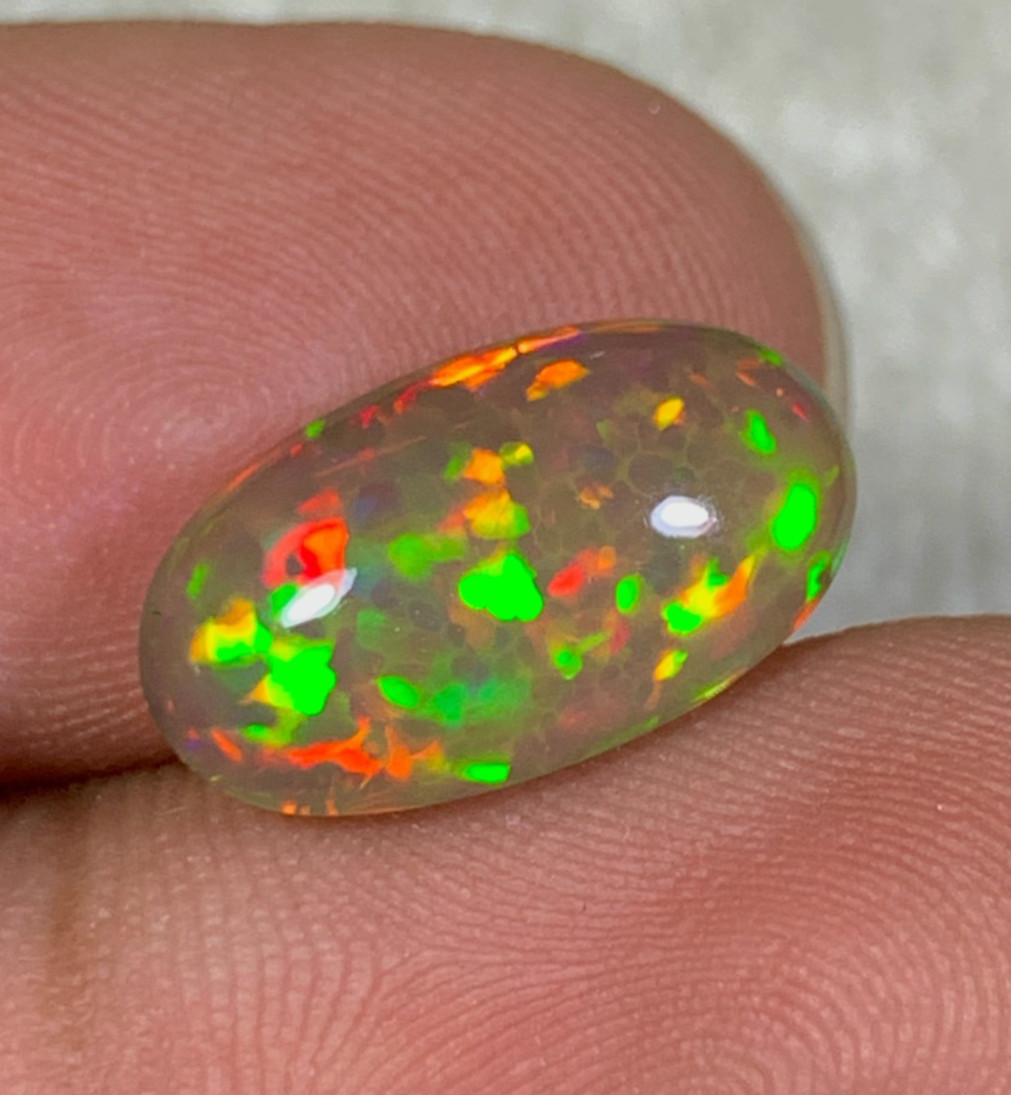 Natural Ethiopian Dark Base Honeycomb Opal 3.05 Carat Multi Fire Oval Cabochon