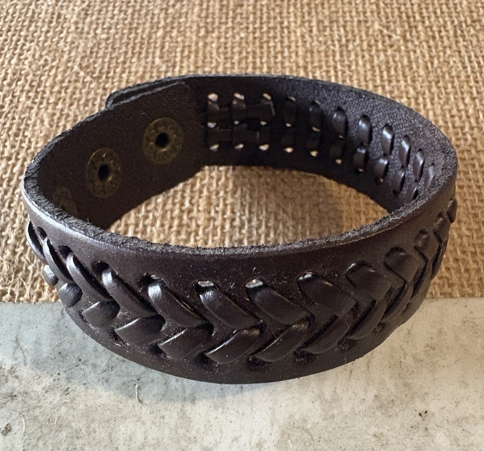 brown braided leather cuff bracelet . adjustable . snap closure . no stone