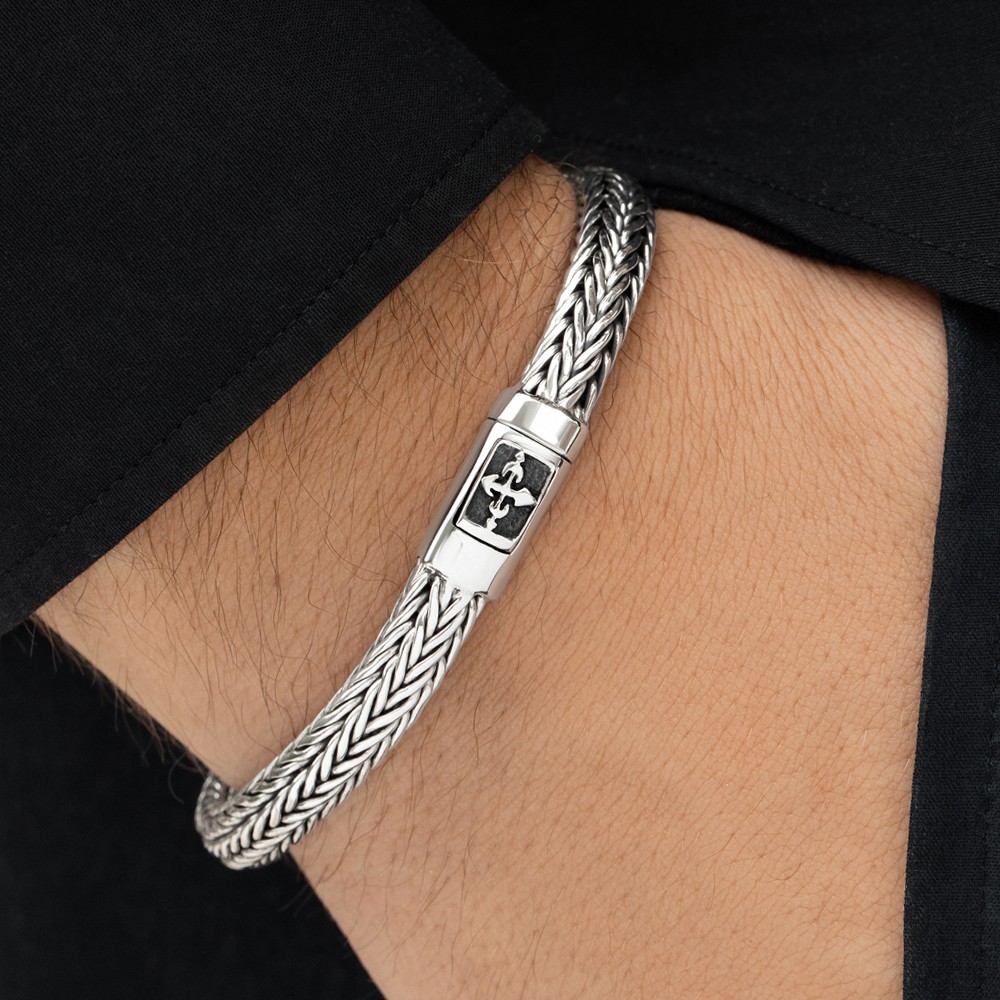 Sleek silver cross bracelet blending faith and modern style for everyday wear.