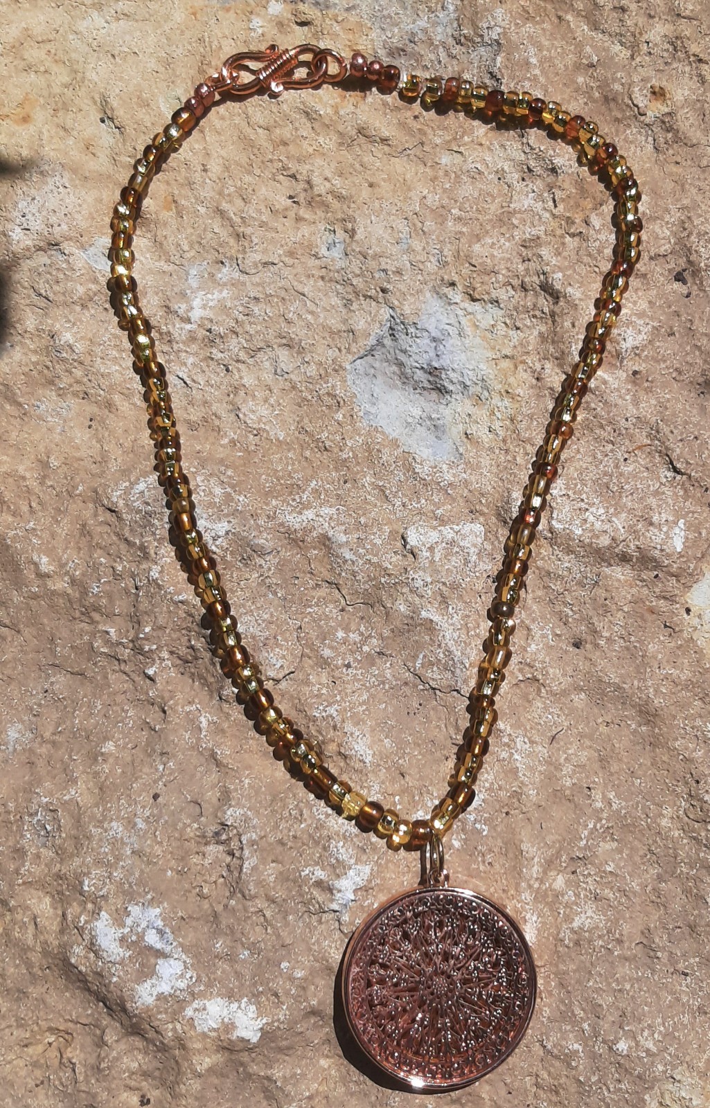 Handmade Jewelry Necklace with amber and gold glass beads,copper colored pendant