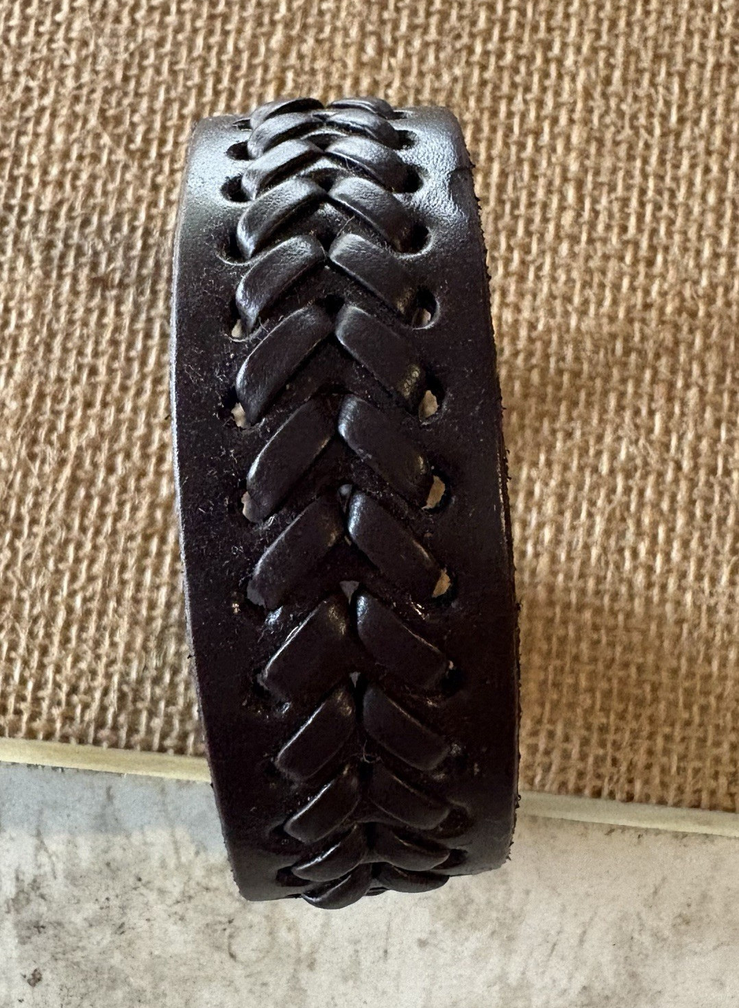brown braided leather cuff bracelet . adjustable . snap closure . no stone