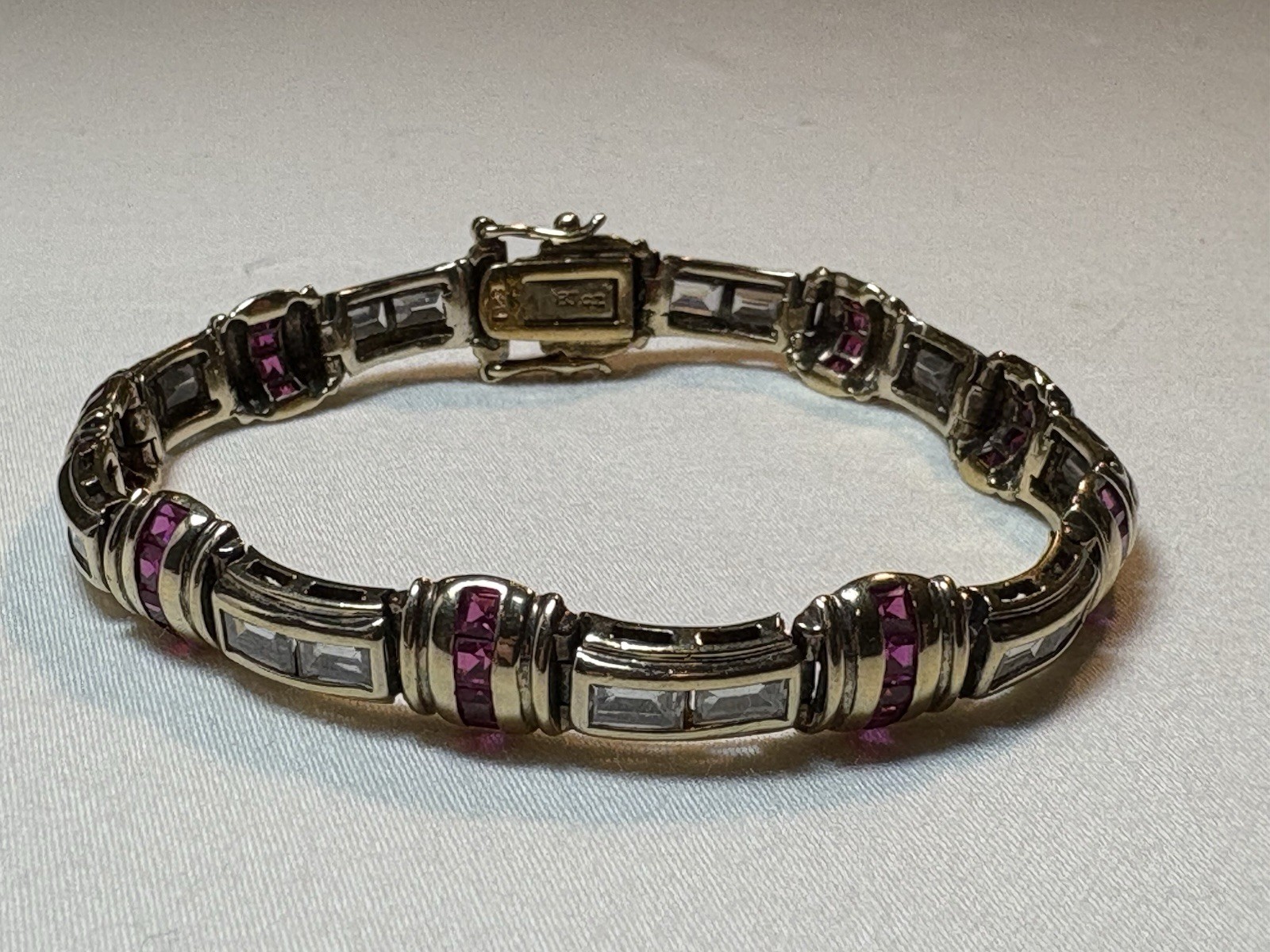 A sterling silver bracelet featuring baguette and round cubic zirconia stones.