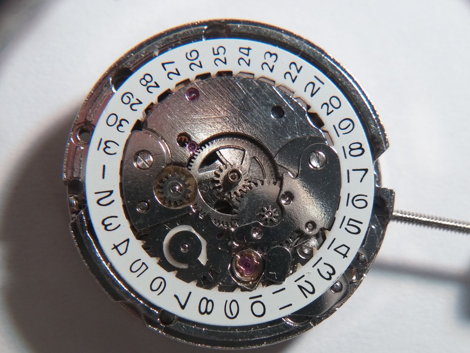 Automatic watch movement, winds. winding stem, running, 19.7mm diameter. no mark