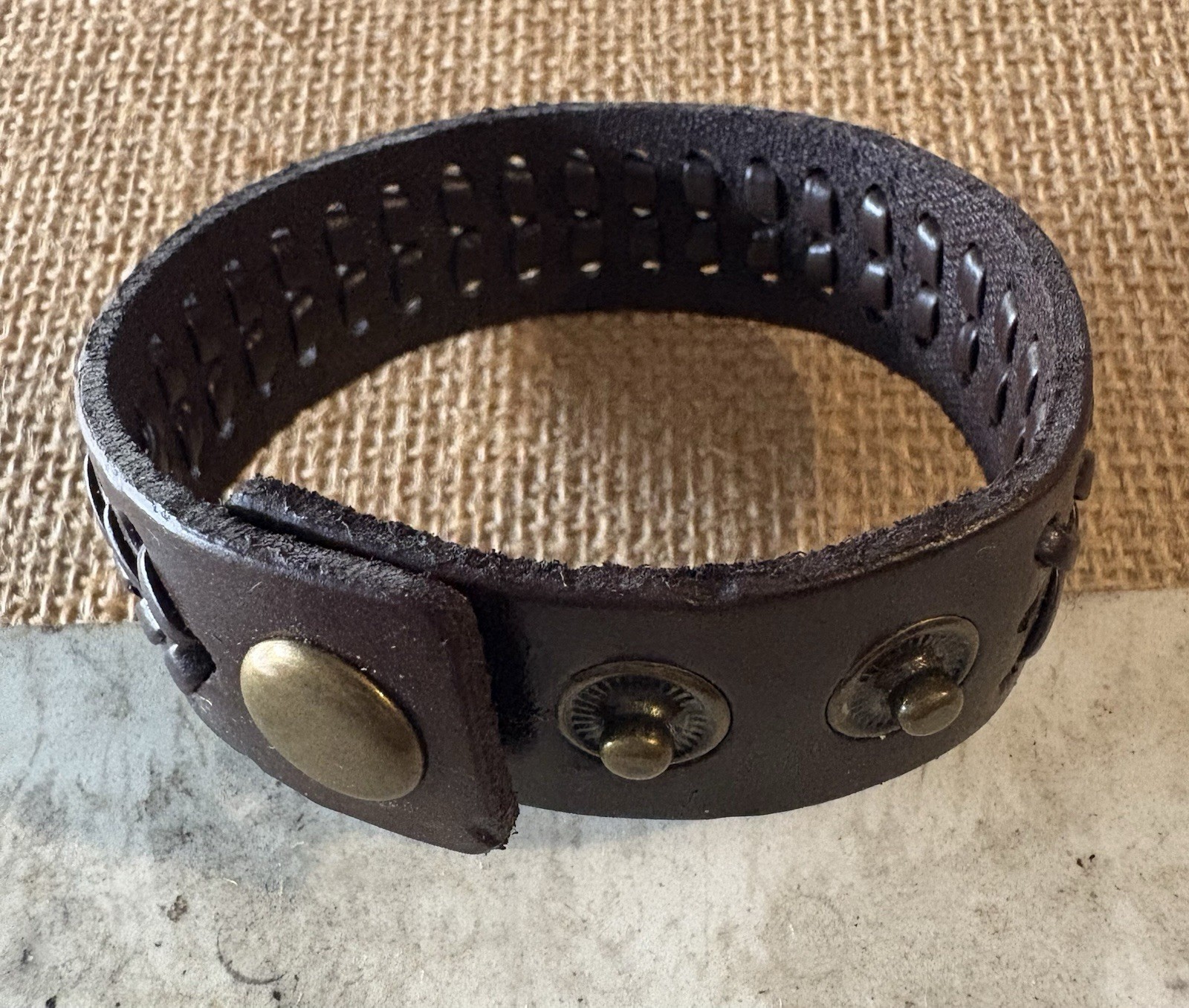 brown braided leather cuff bracelet . adjustable . snap closure . no stone