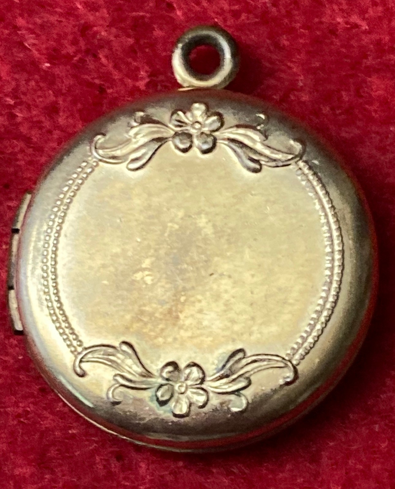 Vintage Gold Tone round locket features a hand-engraved crescent floral motif