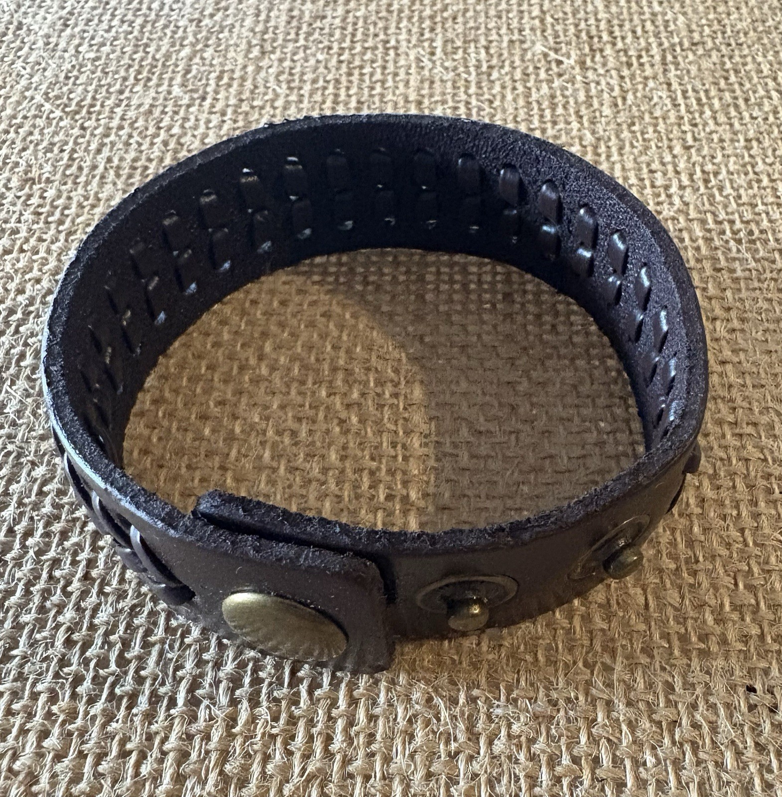 brown braided leather cuff bracelet . adjustable . snap closure . no stone