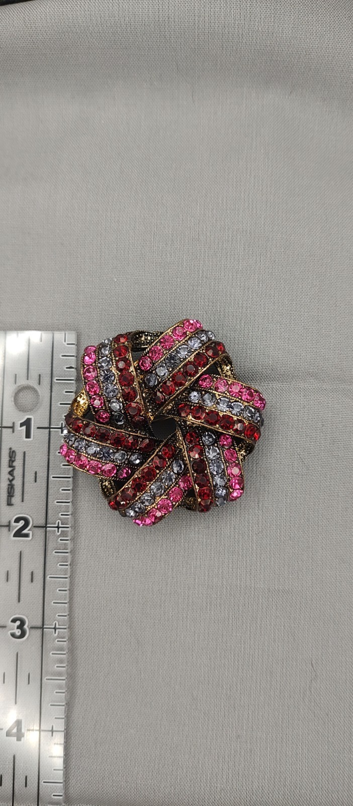 Monet rhinestone knot/ ribbon brooch of the 1970s to mid-1980s in ruby deep red