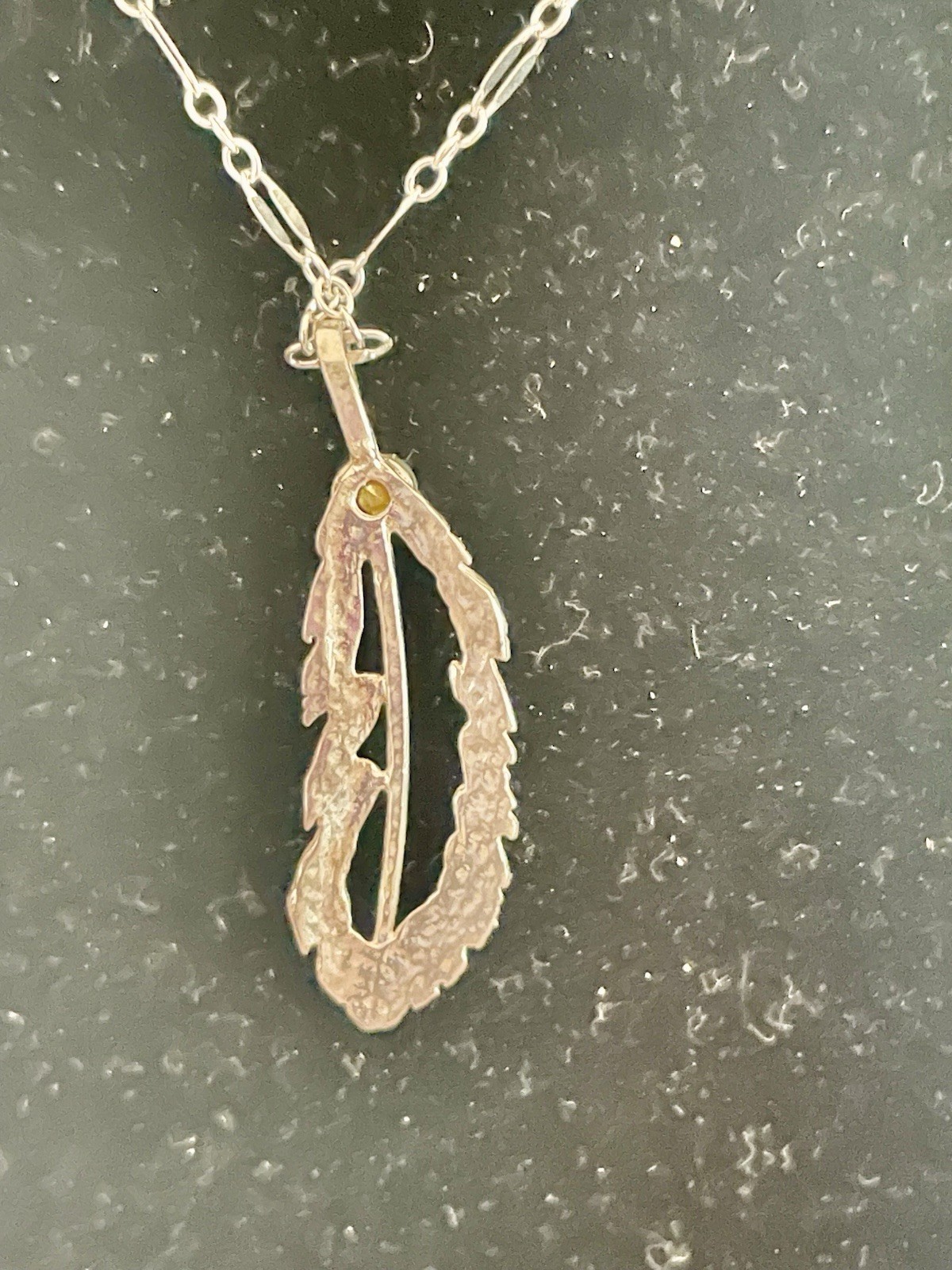 Open Sterling silver 1” Feather On 18” Figaro chain w/ Red Crystal.