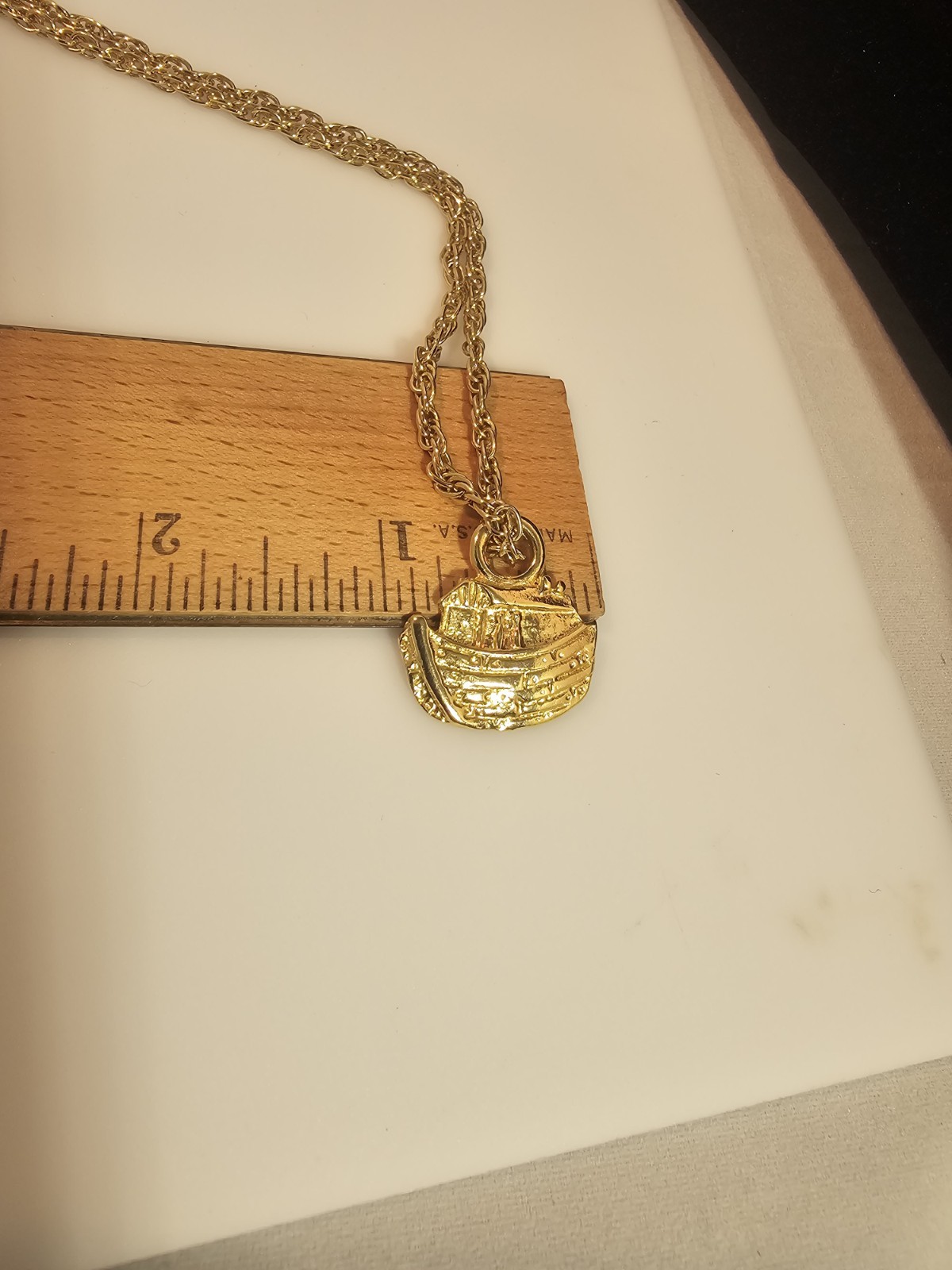 Bright gold tone Noah’s Ark pendant and 24 inch gold tone chain necklace