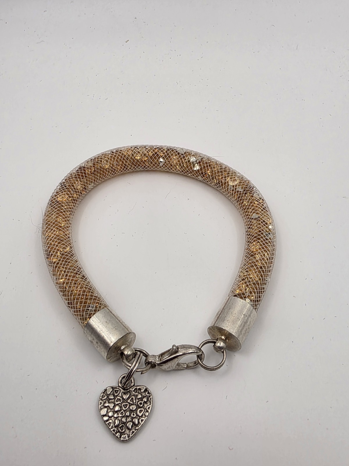 Gold Tone Tubular Mesh Bangle With Crystals And Heart Charm