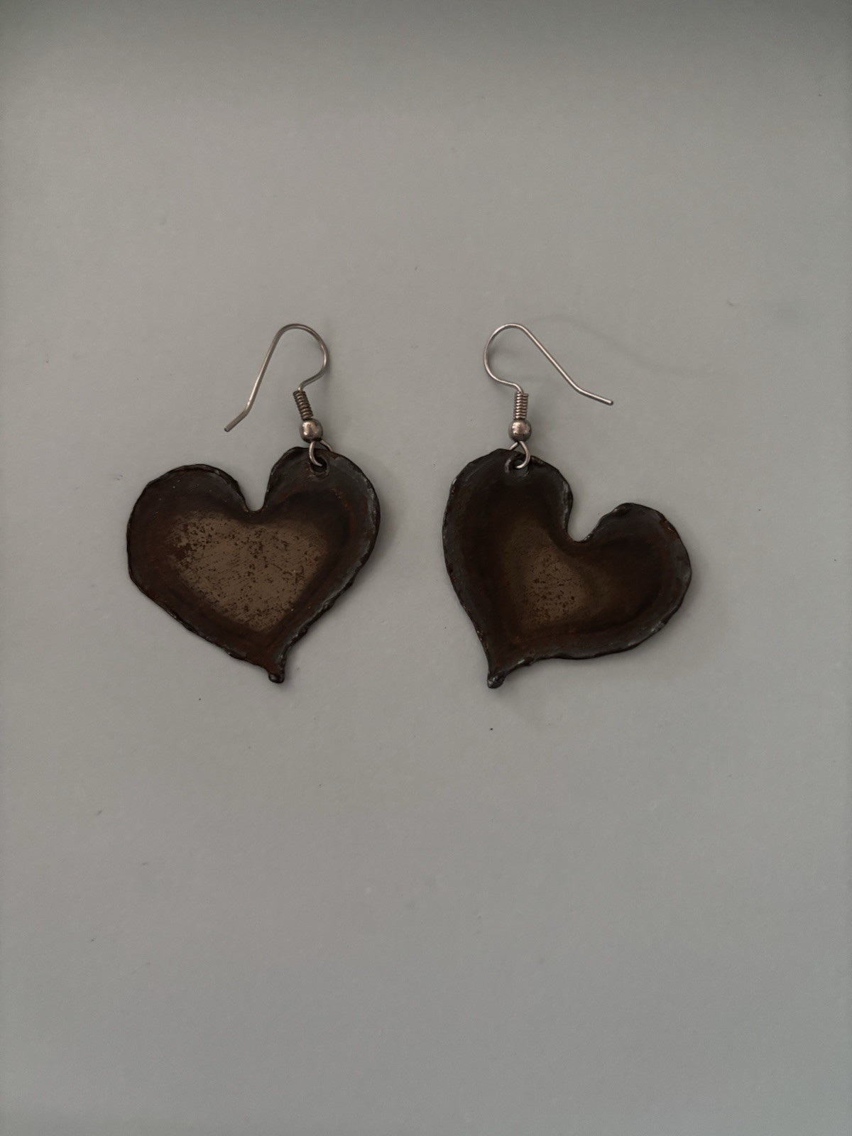 Flame painted copper heart earrings with a unique rainbow patina created by heat