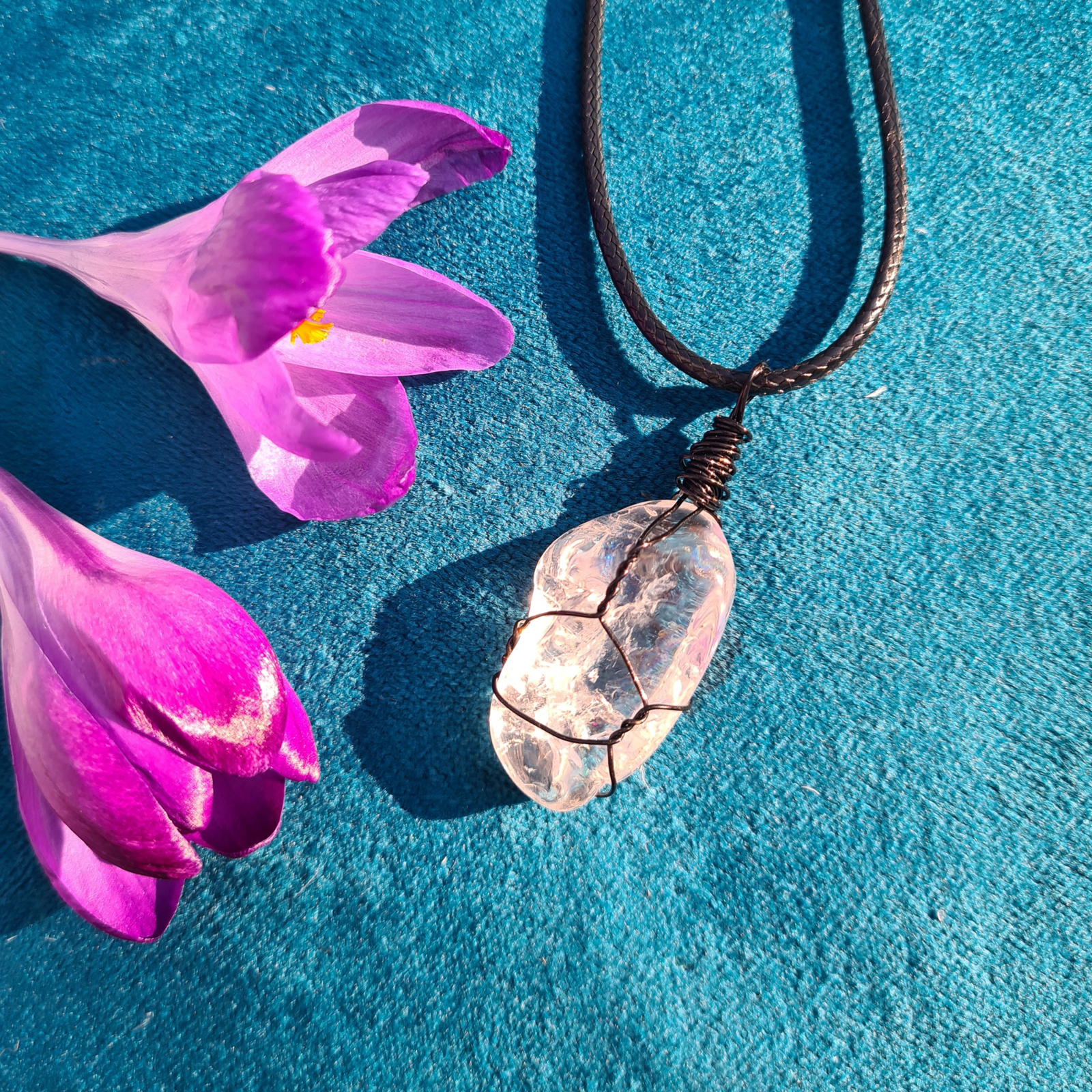 Clear quartz wrapped pendant on a black cord