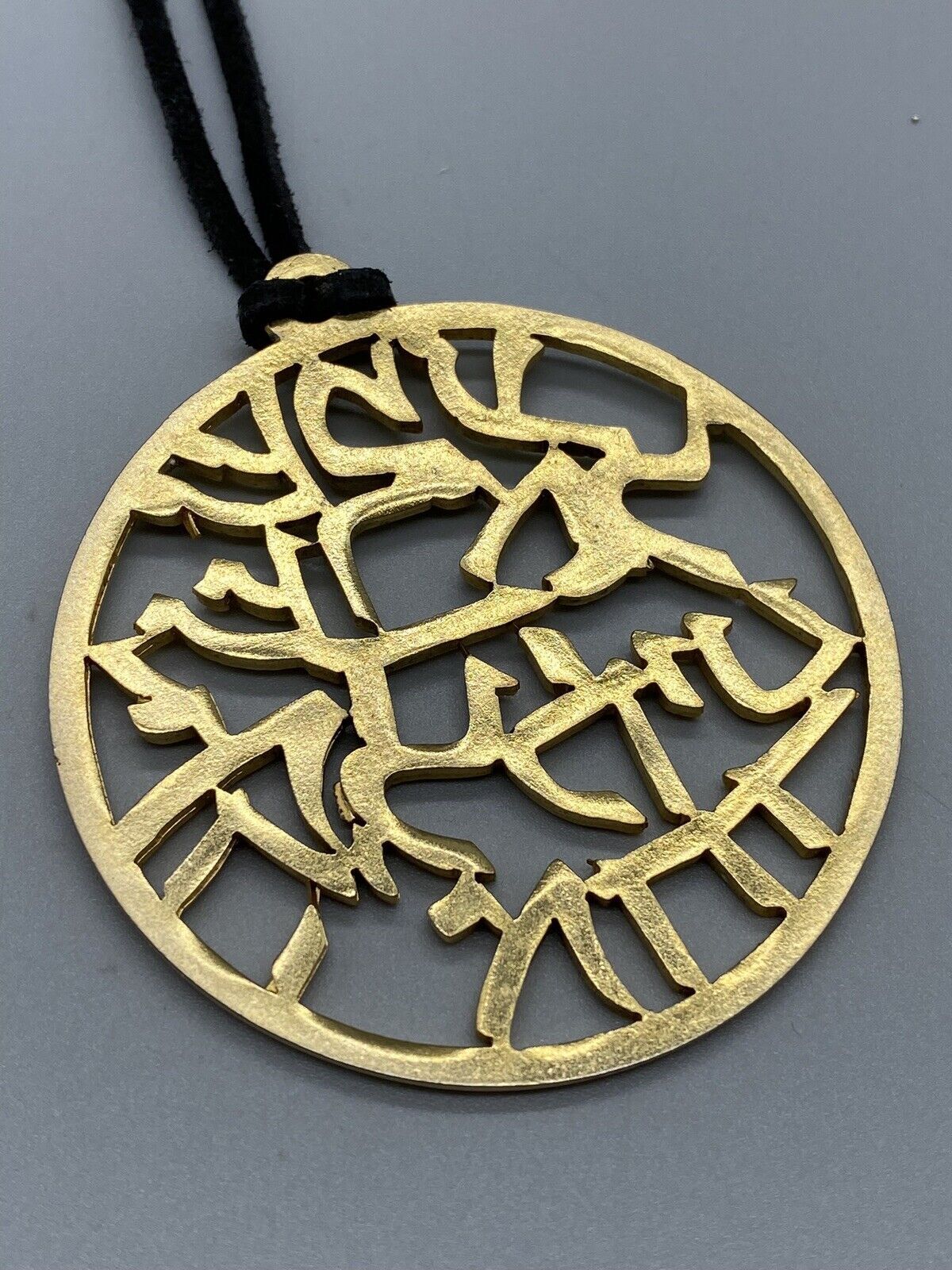 SAGA HIEROGLYPH GOLD TONE ROUND PENDANT BLACK LESTHER NECKLACE