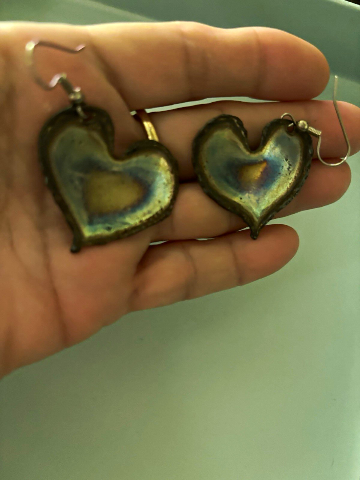 Flame painted copper heart earrings with a unique rainbow patina created by heat