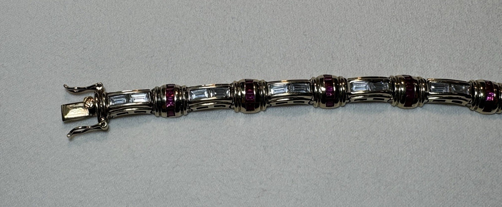 A sterling silver bracelet featuring baguette and round cubic zirconia stones.