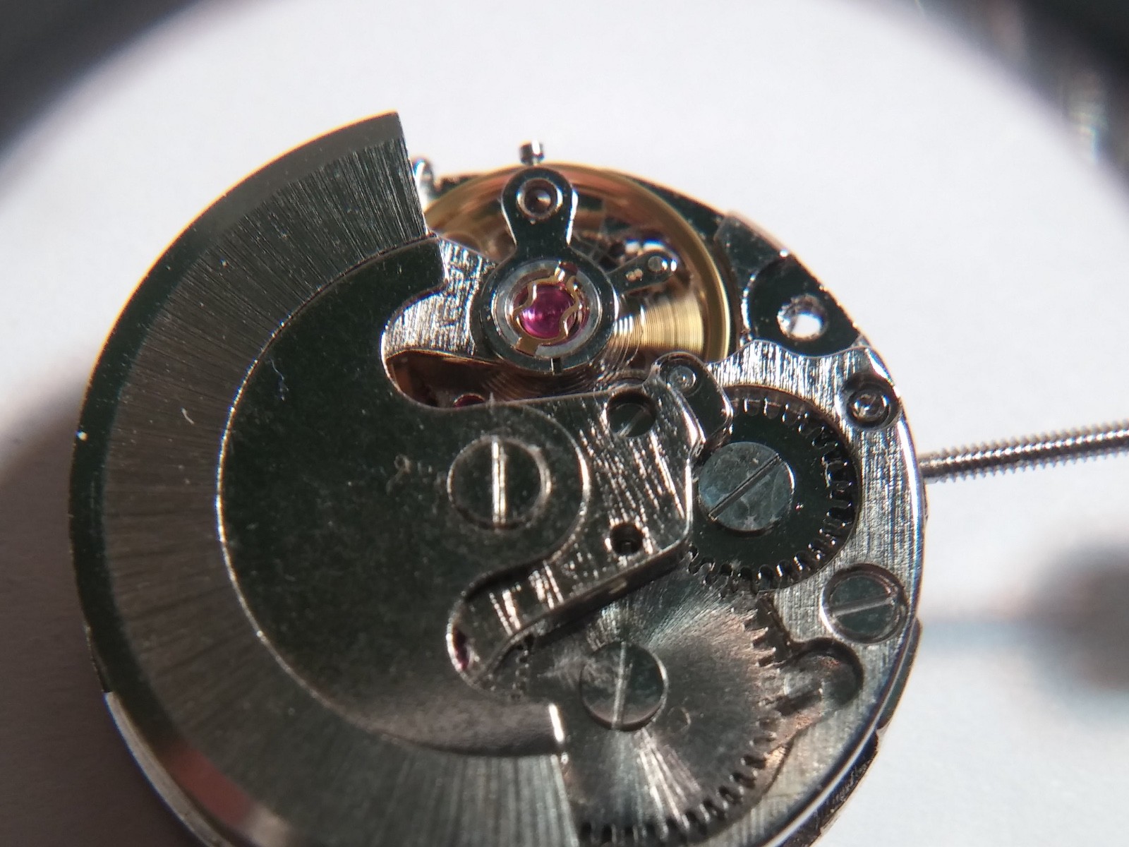 Automatic watch movement, winds. winding stem, running, 19.7mm diameter. no mark