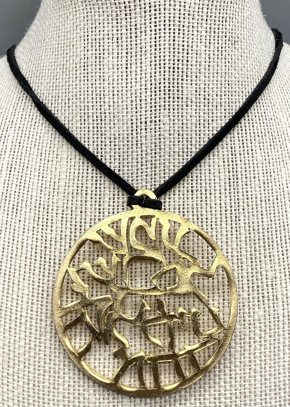 SAGA HIEROGLYPH GOLD TONE ROUND PENDANT BLACK LESTHER NECKLACE
