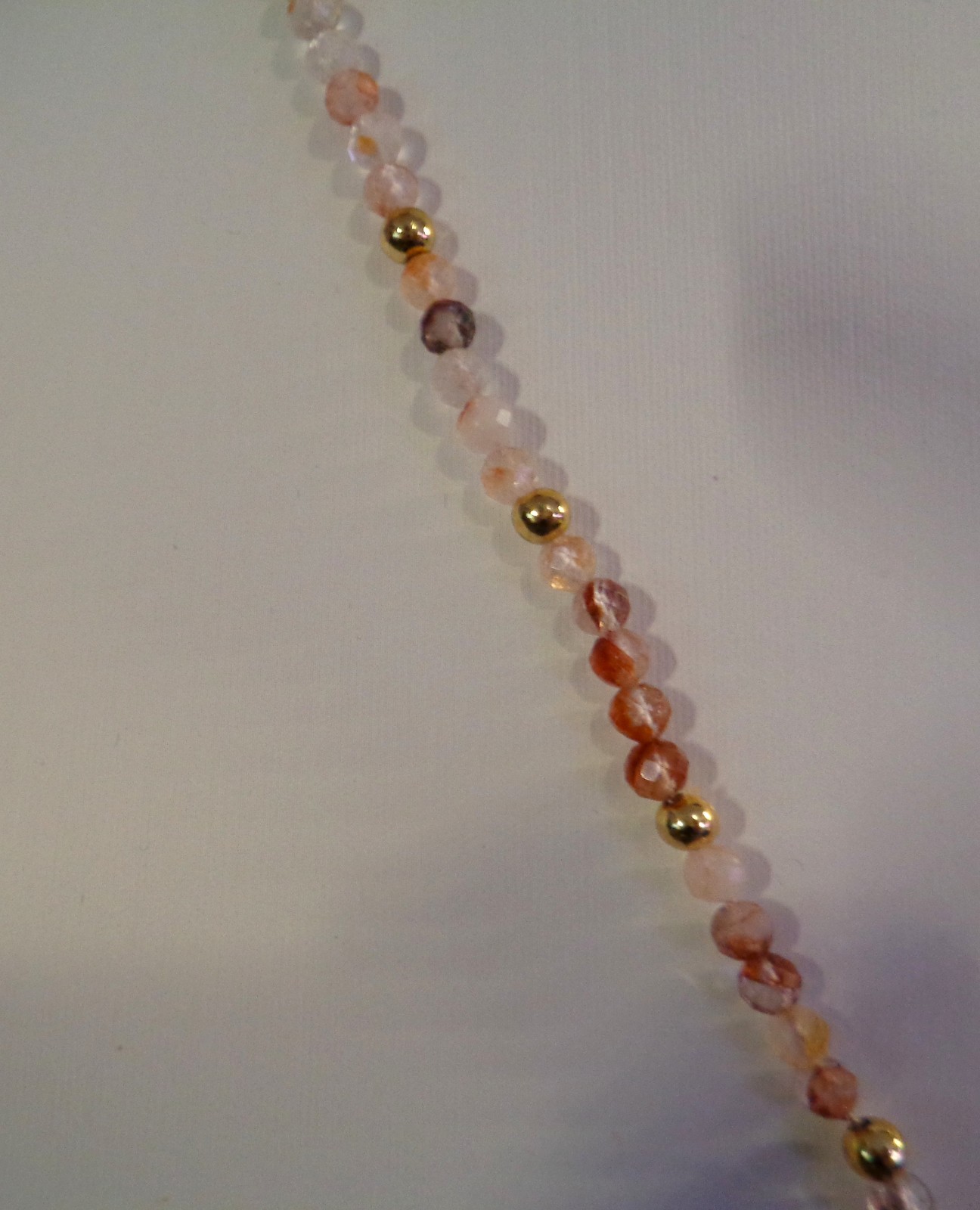Artisan crafted,18”red rutilated quartz strand, hand knotted on silk, featuring